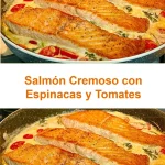 Plato de salmón cremoso con espinacas y tomates frescos en un fondo blanco.