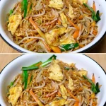 Fideos fritos estilo casero en un plato con vegetales frescos